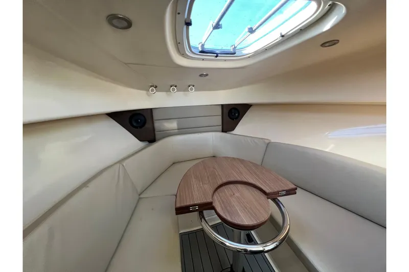Slide: The Image of 2015 Boston Whaler 285 Conquest cabin interior with skylight and seating area. - 10