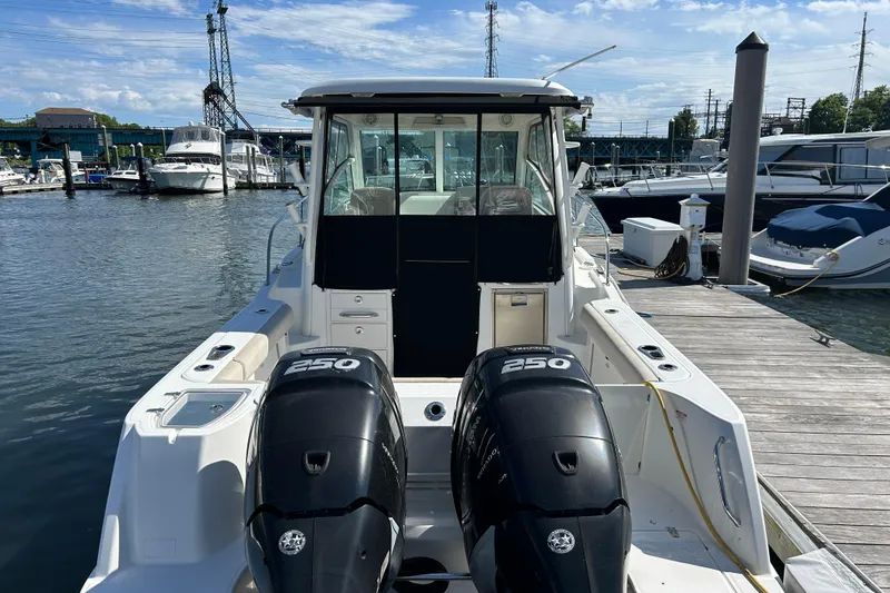 Slide: The Image of 2015 Boston Whaler 285 Conquest docked, featuring dual 250 horsepower engines. - 2