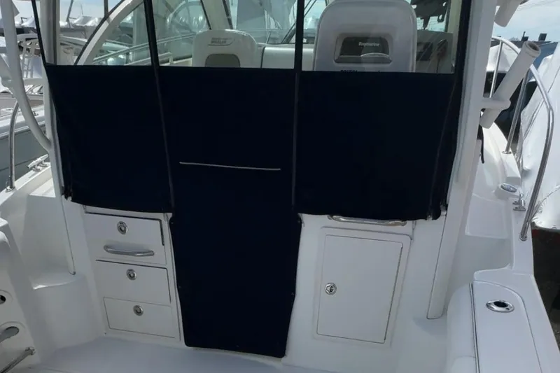 Slide: The Image of 2015 Boston Whaler 285 Conquest cockpit with storage compartments and seating. - 3