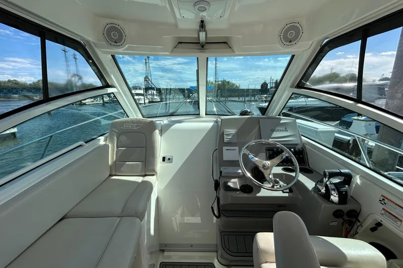 Slide: The Image of 2015 Boston Whaler 285 Conquest helm with Garmin navigation, docked at marina. - 5
