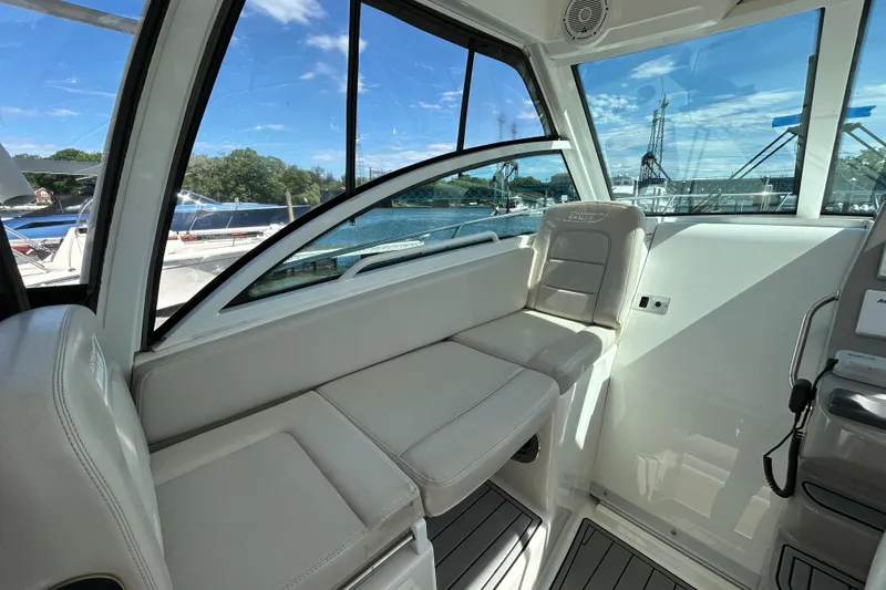 Slide: The Image of Interior of 2015 Boston Whaler 285 Conquest boat with seating and windows. - 8