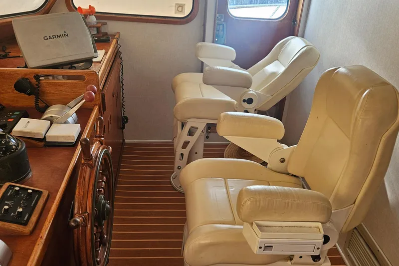 Slide: The Image of Interior of 1988 Cheoy Lee 51 Yacht with helm and leather seats. - 14