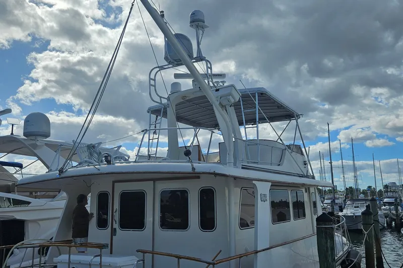 Slide: The Image of 1988 Cheoy Lee 51 Long Range Cockpit Motor Yacht docked under cloudy sky. - 18