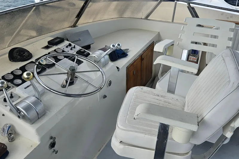 Slide: The Image of Cockpit of 1988 Cheoy Lee 51 Long Range Motor Yacht with steering wheel and controls. - 19