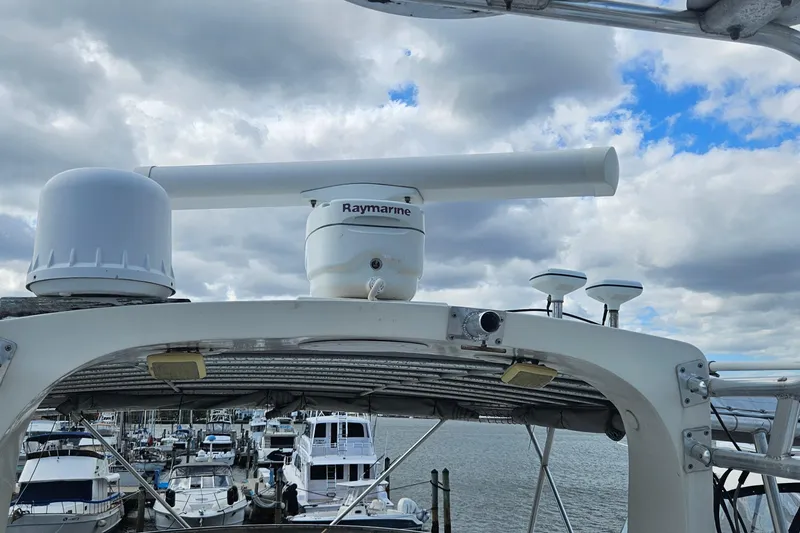 Slide: The Image of Radar equipment on 1988 Cheoy Lee 51 Long Range Cockpit Motor Yacht, docked under cloudy sky. - 23