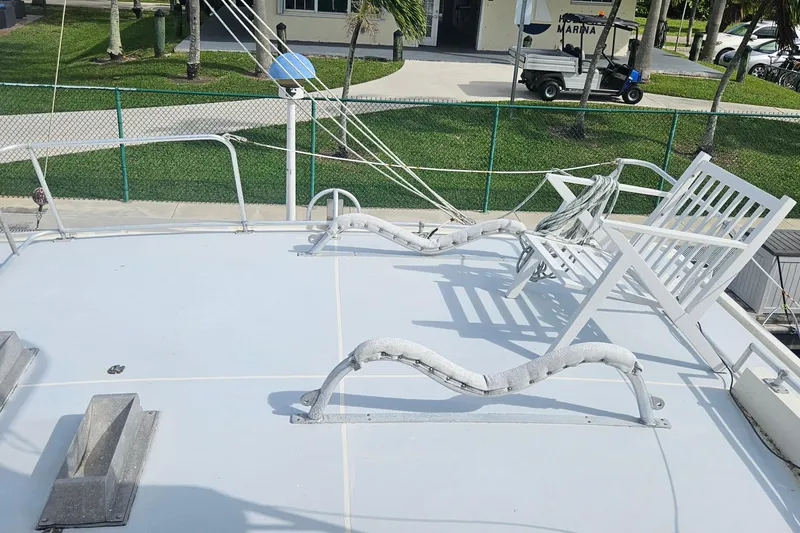 Slide: The Image of 1988 Cheoy Lee 51 Long Range Cockpit Motor Yacht deck with chairs and railing. - 27