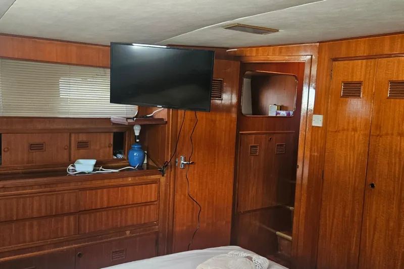 Slide: The Image of Interior of 1988 Cheoy Lee 51 Yacht with wood paneling and mounted TV. - 32