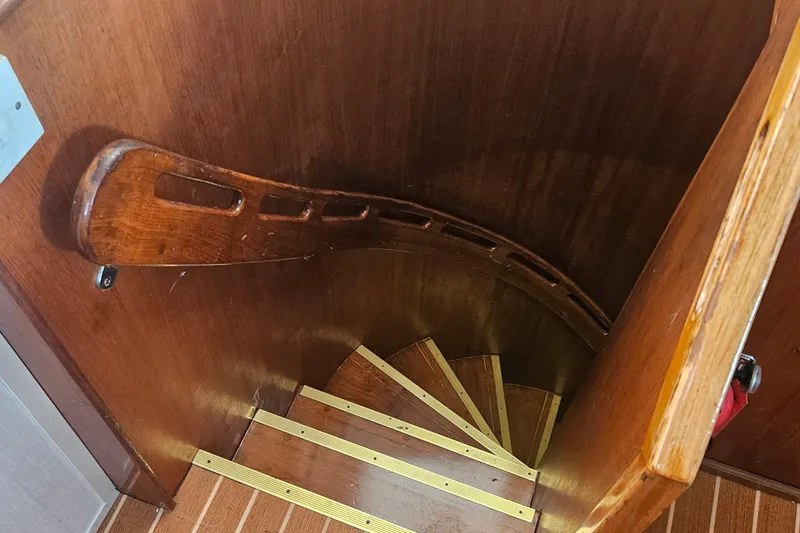 Slide: The Image of Wooden spiral staircase inside 1988 Cheoy Lee 51 Long Range Cockpit Motor Yacht. - 38