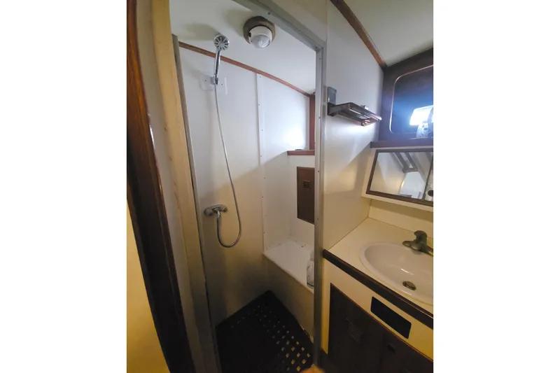 Slide: The Image of Bathroom interior of 1988 Cheoy Lee 51 Long Range Cockpit Motor Yacht, featuring shower and sink. - 42