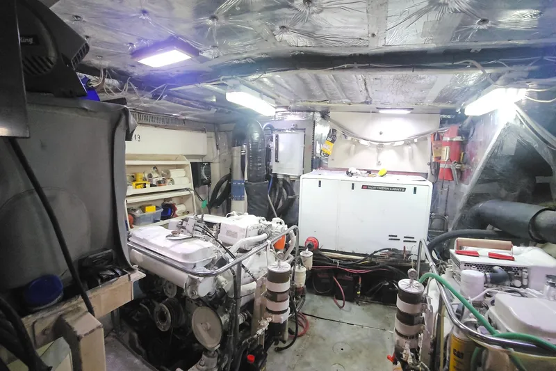 Slide: The Image of Engine room of 1988 Cheoy Lee 51 Long Range Cockpit Motor Yacht, featuring machinery and equipment. - 44