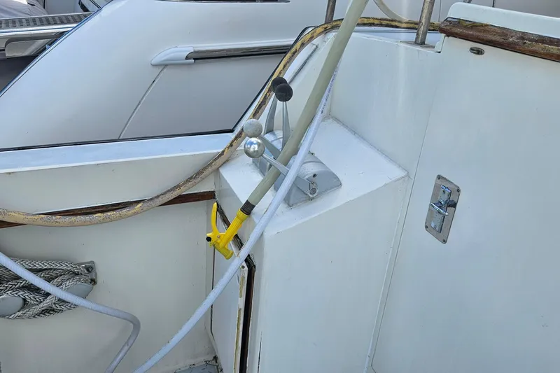 Slide: The Image of 1988 Cheoy Lee 51 Long Range Cockpit Motor Yacht deck with ropes and controls. - 6