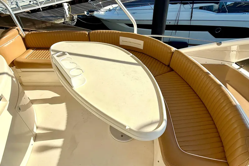 Slide: The Image of Luxurious seating area on a 2000 Fairline Squadron 55 yacht with a sleek table. - 12
