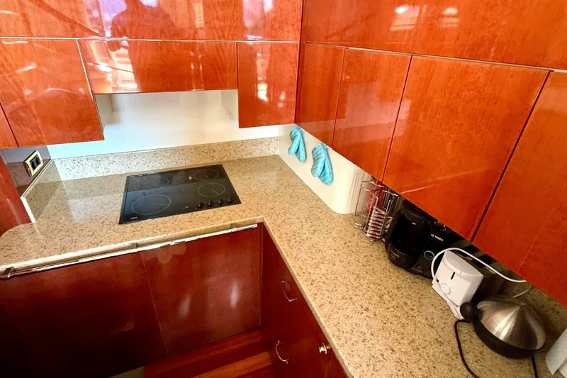 Slide: The Image of Luxurious kitchen in 2000 Fairline Squadron 55 yacht with sleek wooden cabinets. - 13