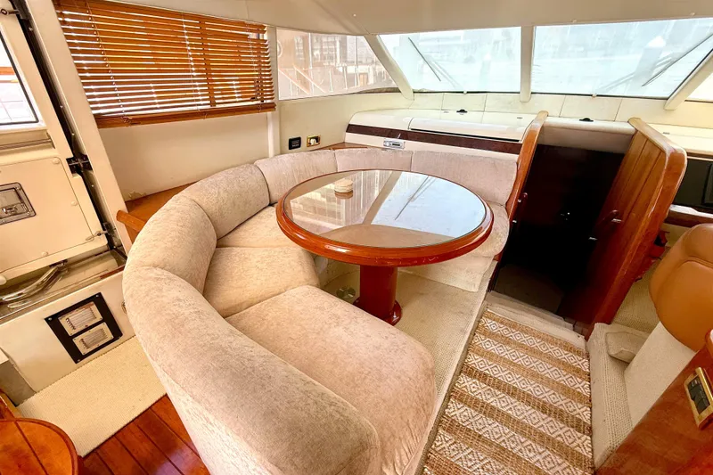 Slide: The Image of Luxurious interior of 2000 Fairline Squadron 55 yacht with plush seating and wooden table. - 6