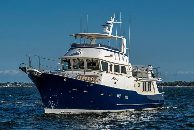 The Image of 2017 Kadey-Krogen 58EB yacht cruising on open water under clear blue skies. - 0