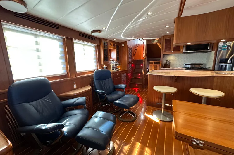 Slide: The Image of Luxurious interior of 2017 Kadey-Krogen 58EB yacht with leather chairs and wooden finishes. - 13