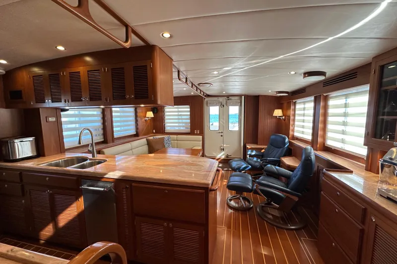 Slide: The Image of Luxurious 2017 Kadey-Krogen 58EB yacht interior with elegant wood finishes and comfortable seating. - 14