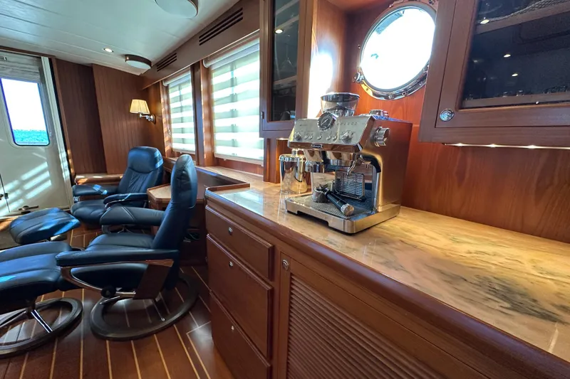 Slide: The Image of Luxurious interior of 2017 Kadey-Krogen 58EB yacht with espresso machine and leather chairs. - 16