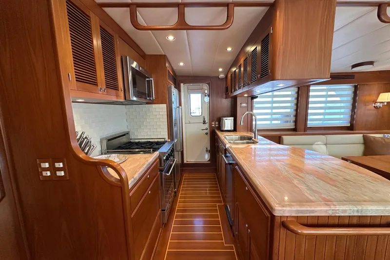 Slide: The Image of Luxurious 2017 Kadey-Krogen 58EB yacht kitchen with wood cabinetry and modern appliances. - 18