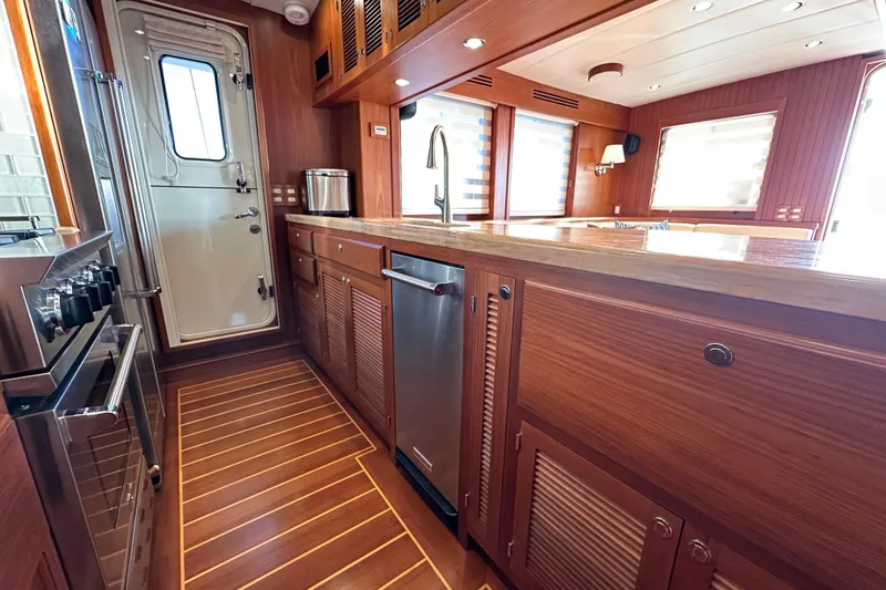 Slide: The Image of Luxurious 2017 Kadey-Krogen 58EB yacht kitchen with wood cabinetry and modern appliances. - 19