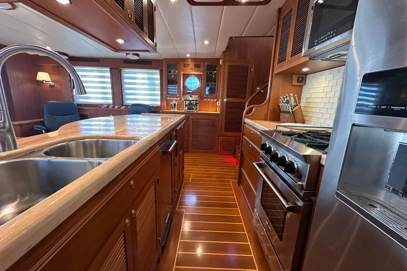 Slide: The Image of Luxurious 2017 Kadey-Krogen 58EB yacht kitchen with modern appliances and elegant wood finishes. - 21