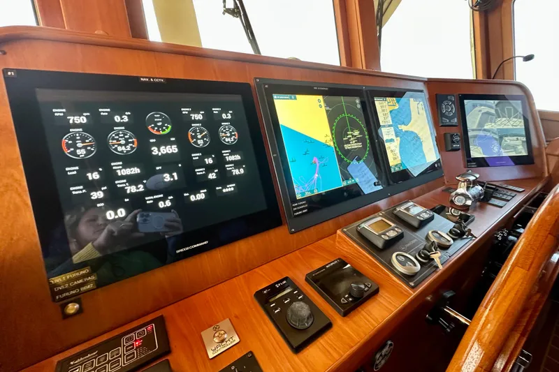 Slide: The Image of Control panel of 2017 Kadey-Krogen 58EB yacht with navigation and monitoring screens. - 23
