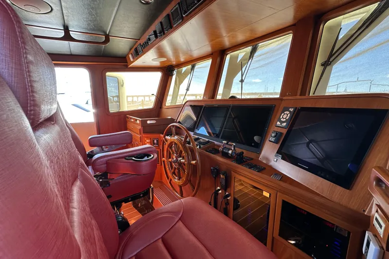 Slide: The Image of Pilothouse interior of 2017 Kadey-Krogen 58EB yacht with leather seating and navigation equipment. - 24