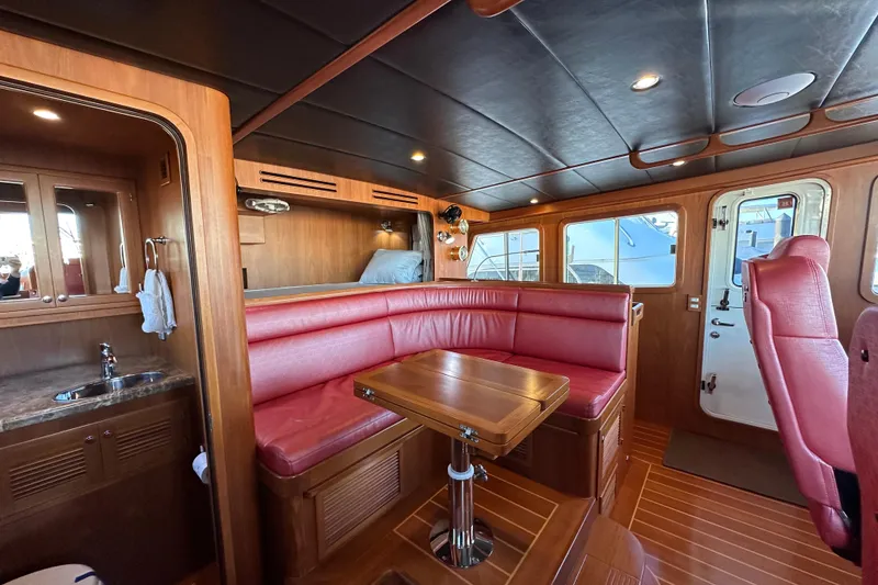 Slide: The Image of Luxurious 2017 Kadey-Krogen 58EB yacht interior with red seating and wooden finishes. - 26