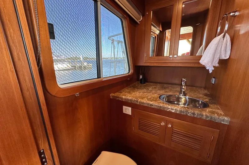 Slide: The Image of Luxurious 2017 Kadey-Krogen 58EB yacht bathroom with wood finish and marble countertop. - 28