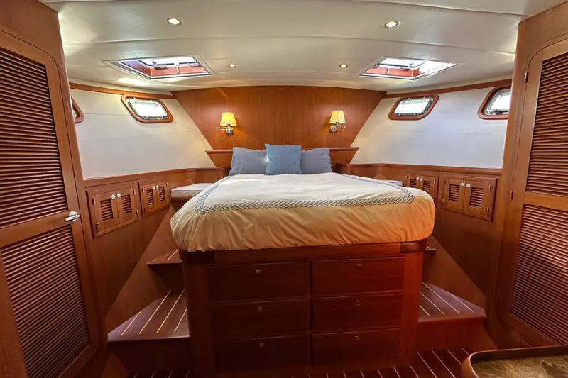 Slide: The Image of Luxurious 2017 Kadey-Krogen 58EB yacht bedroom with wood paneling and skylights. - 35