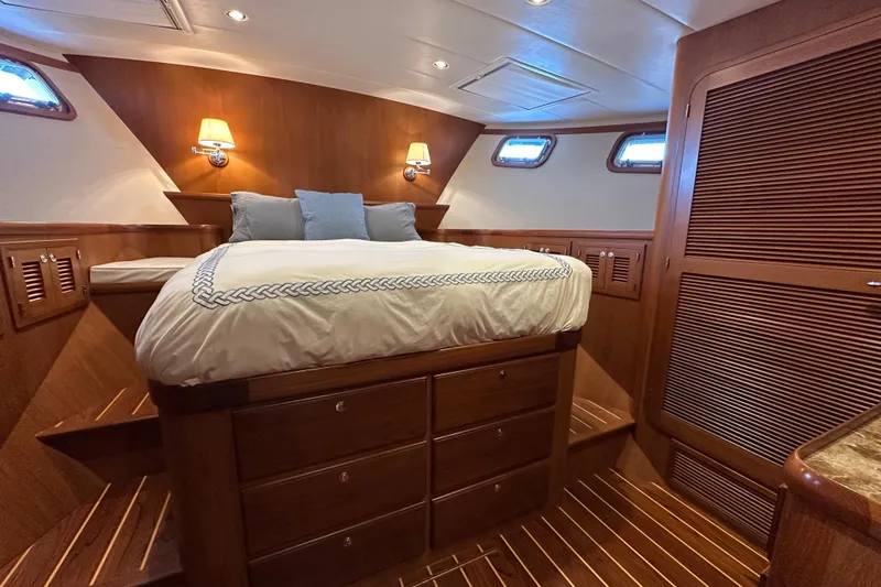 Slide: The Image of Luxurious 2017 Kadey-Krogen 58EB yacht bedroom with wood paneling and cozy lighting. - 36