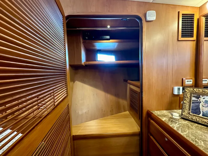 Slide: The Image of Interior of 2017 Kadey-Krogen 58EB yacht with wooden finishes and a small window. - 39
