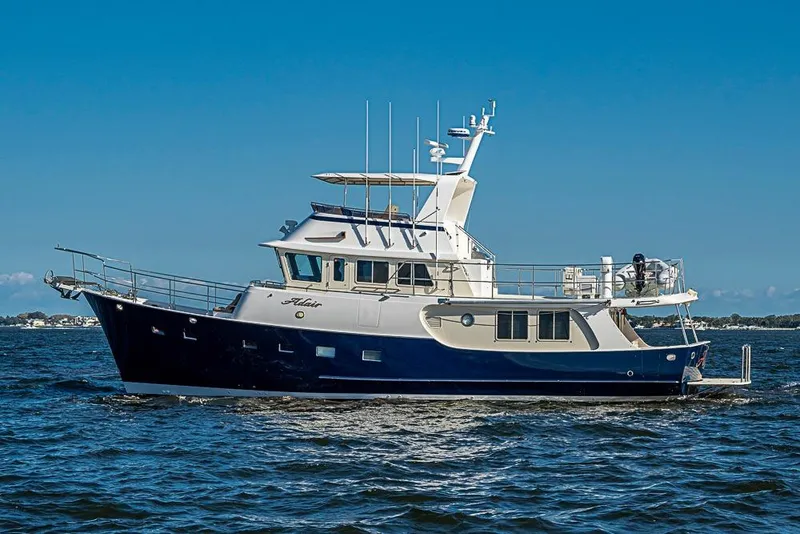 Slide: The Image of Kadey-Krogen 58EB 2017 yacht cruising on open water under clear blue sky. - 4