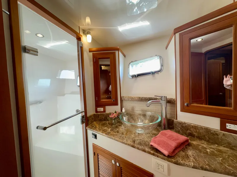 Slide: The Image of Luxurious bathroom in 2017 Kadey-Krogen 58EB yacht with glass sink and marble countertop. - 41