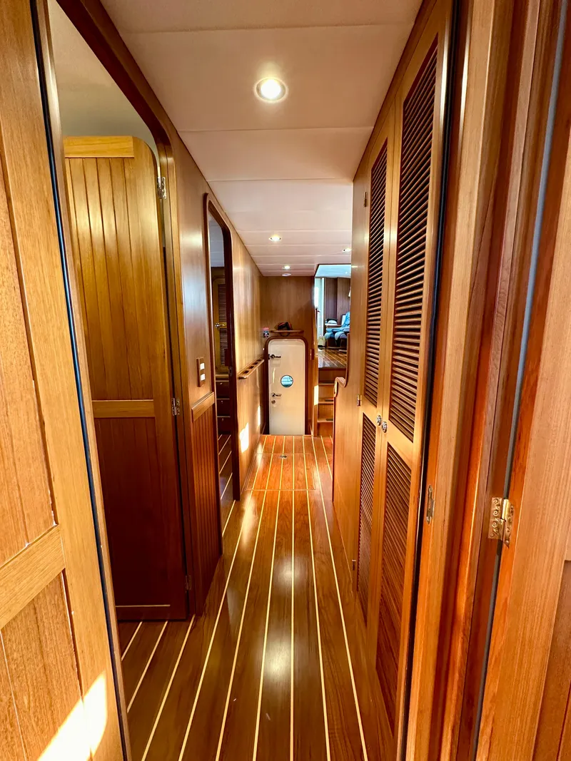 Slide: The Image of 2017 Kadey-Krogen 58EB yacht interior hallway with wooden finishes. - 42