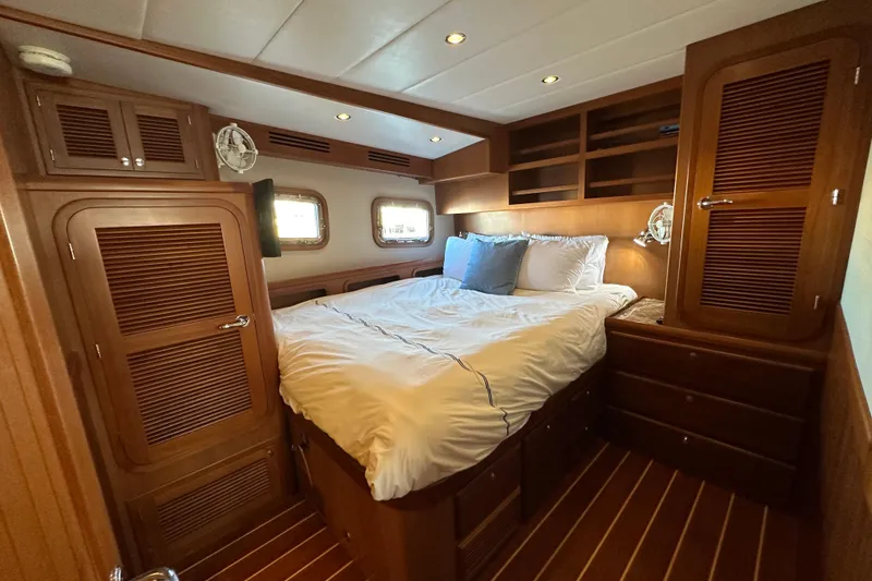 Slide: The Image of Luxurious 2017 Kadey-Krogen 58EB yacht bedroom with wood paneling and cozy bedding. - 44