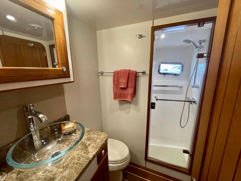 Slide: The Image of Luxurious 2017 Kadey-Krogen 58EB yacht bathroom with glass sink and shower. - 46