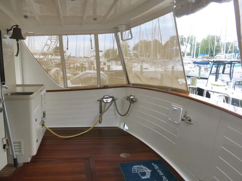 Slide: The Image of 2017 Kadey-Krogen 58EB yacht deck with wood flooring and marina view. - 52
