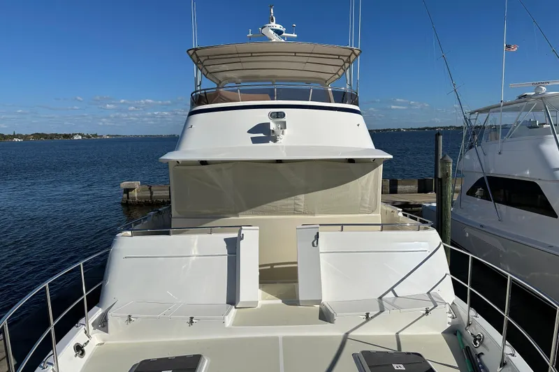 Slide: The Image of 2017 Kadey-Krogen 58EB yacht docked at marina, clear blue sky background. - 62