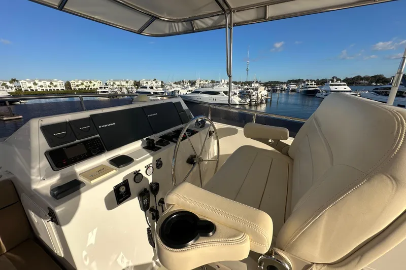 Slide: The Image of Helm of 2017 Kadey-Krogen 58EB yacht with marina view and navigation equipment. - 69
