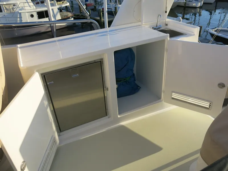 Slide: The Image of Kadey-Krogen 58EB 2017 yacht storage compartments with open doors at marina. - 71