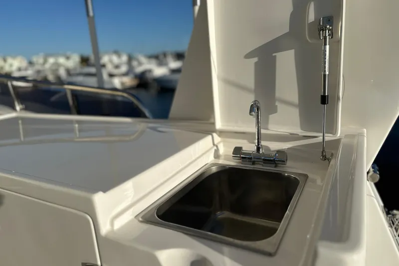 Slide: The Image of Outdoor sink on 2017 Kadey-Krogen 58EB yacht, with marina in background. - 73