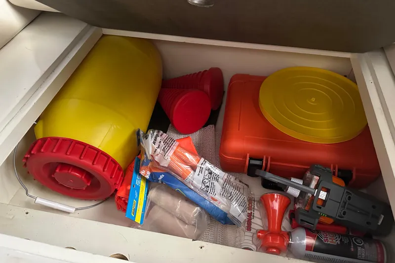 Slide: The Image of Storage compartment with safety equipment on a 2017 Kadey-Krogen 58EB boat. - 81
