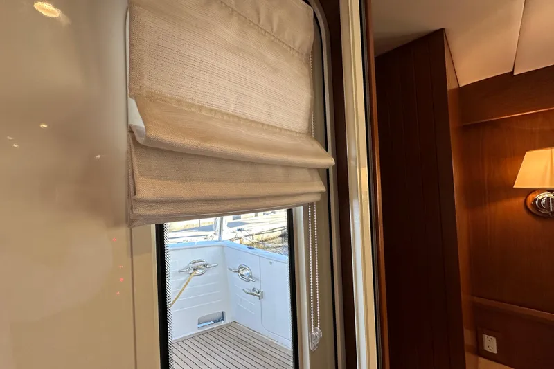 Slide: The Image of Interior view of 2017 Kadey-Krogen 58EB yacht, featuring window with beige blinds. - 83