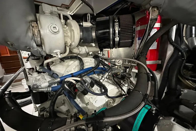 Slide: The Image of Engine room of 2017 Kadey-Krogen 58EB yacht, featuring complex machinery and fire extinguisher. - 96