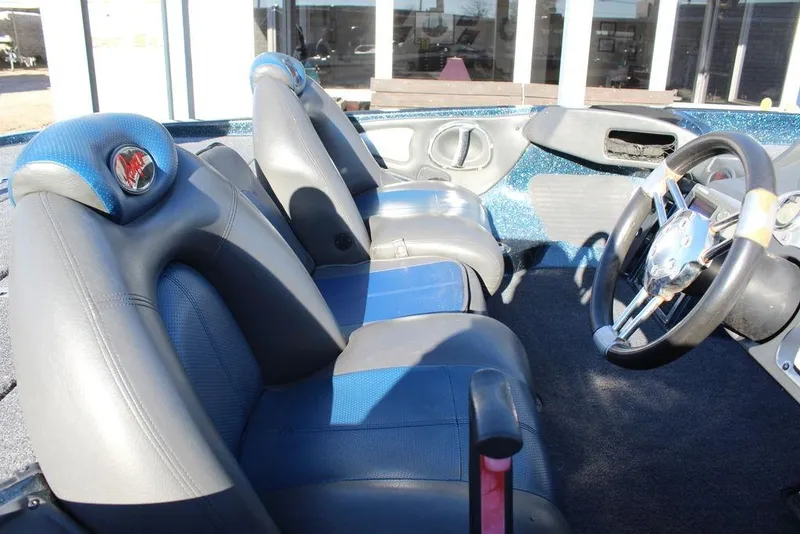 Slide: The Image of 2007 Ranger Z20 Comanche boat interior with blue and gray seating and steering wheel. - 13