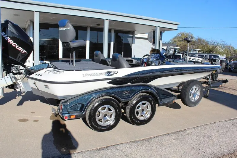 Slide: The Image of 2007 Ranger Z20 Comanche boat with Mercury engine on trailer, parked outdoors. - 5