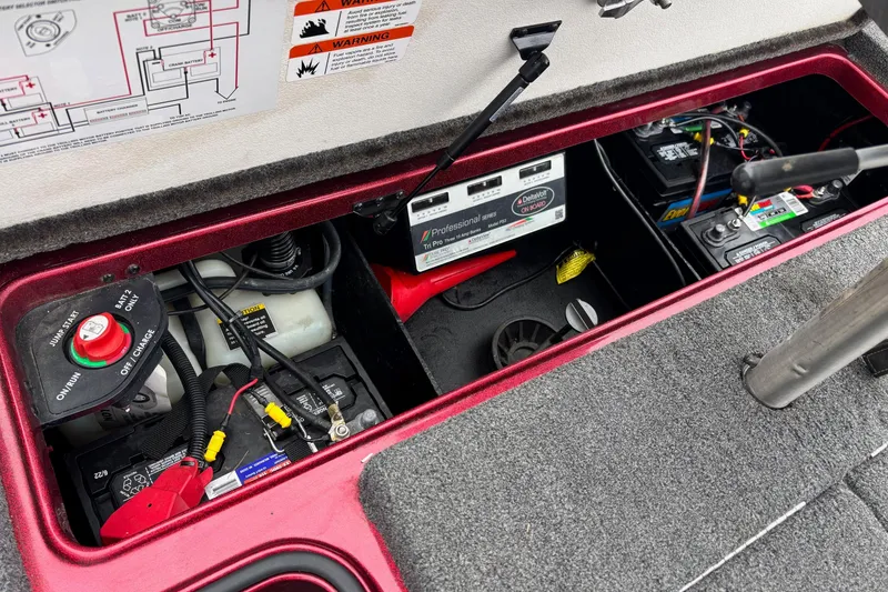Slide: The Image of 2018 Ranger Z518 Comanche boat battery compartment with wiring and control panel. - 10