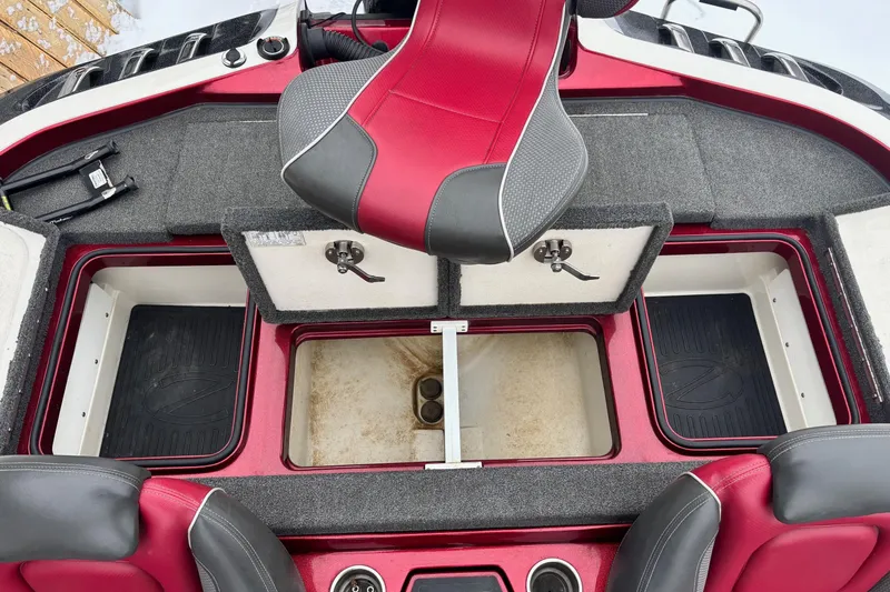 Slide: The Image of 2018 Ranger Z518 Comanche boat interior with red seats and storage compartments. - 11