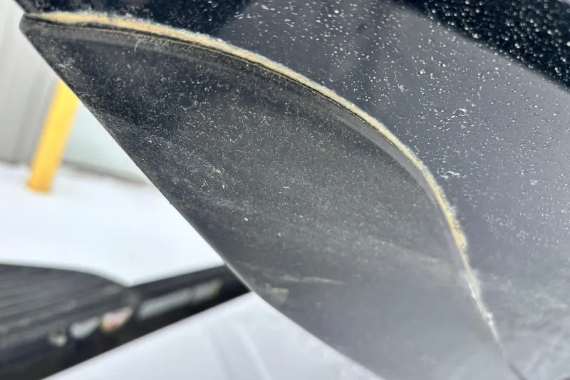 Slide: The Image of Close-up of a 2018 Ranger Z518 Comanche boat hull with visible wear. - 4